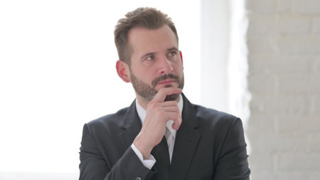 Pensive Young Businessman Thinking about New Projectの写真素材