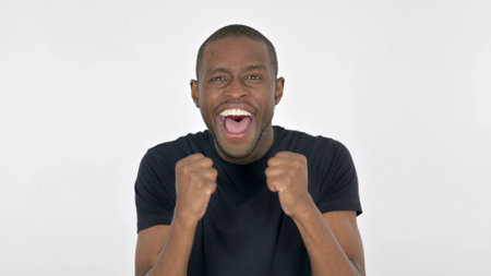 Successful Young African Man Celebrating on White Backgroundの写真素材