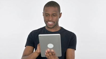 Young African Man using Digital Tablet on White Background