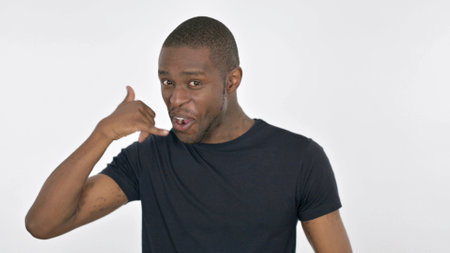 Call Me Gesture by Young African Man on White Backgroundの写真素材