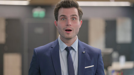 Portrait of Excited Businessman Celebrating Successの写真素材