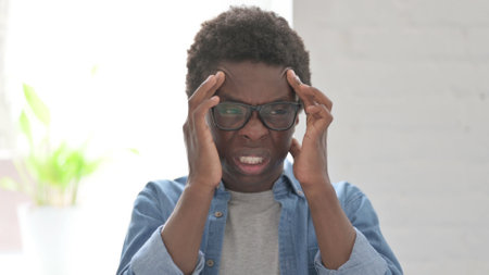 Portrait of Young African Man having Headache