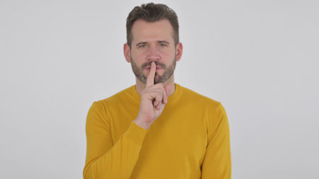 Middle Aged Man Showing Quiet Sign by Finger on Lips , White Background