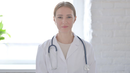 Female Doctor Shaking Head in Approvalの写真素材