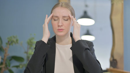 Portrait of Tired Young Businesswoman with Headache, Migraineの写真素材