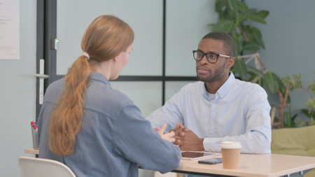 African American Man Talking with Woman in Officeの写真素材