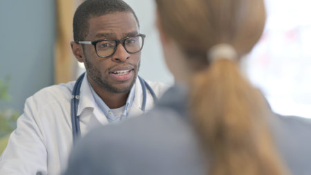 African American Doctor Talking with Female Patientの写真素材