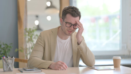 Headache, Tired Young Businessman having Pain in Headの写真素材