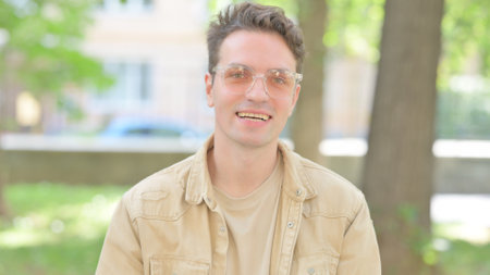 Blogging Casual Young Man Doing Online Video Chat Outdoorの写真素材