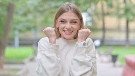 Outdoor Portrait of Woman Celebrating Successの写真素材