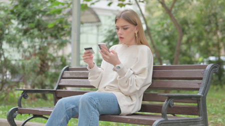 Casual Young Woman Upset by Online Payment Failureの写真素材