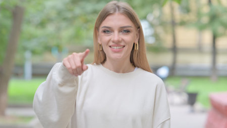 Outdoor Portrait of Woman Pointing at Cameraの写真素材