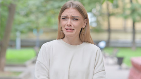 Portrait of Crying Woman Standing Outdoorの写真素材