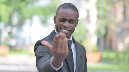 Outdoor Portrait of African Businessman Inviting New Peopleの写真素材
