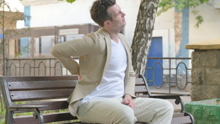 Young Man Sitting Outdoor with Back Painの写真素材