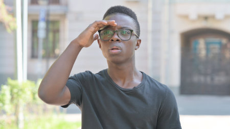 Outdoor Portrait of Young African Man Searching for Opportunityの写真素材
