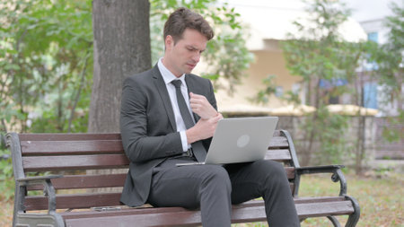 Young Businessman Using Laptop Outdoorの写真素材