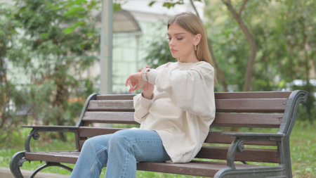 Casual Young Woman using Smart Watch Outdoorの写真素材