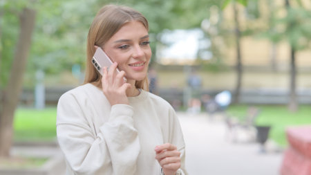 Busy Woman Talking on Phone Outdoorの写真素材