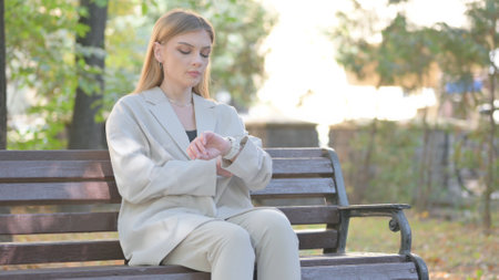 Waiting Young Business Lady Checking Time on Watch Outdoorの写真素材