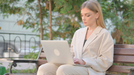 Young Business Lady Working on Laptop Outdoorの写真素材