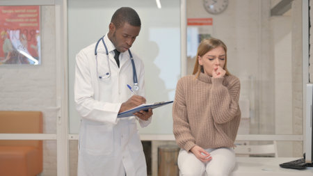 Coughing Female Patient Discussing Health issues with African Doctorの写真素材