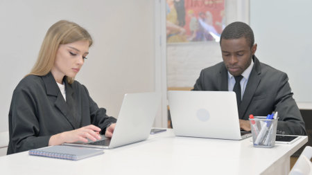 Business People Working on Laptops in Officeの写真素材