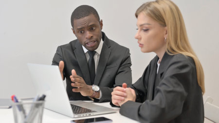 Business People Working on Laptop in Office Togetherの写真素材