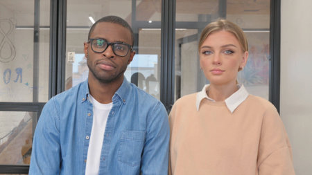 Portrait of Serious Interracial Couple in Office