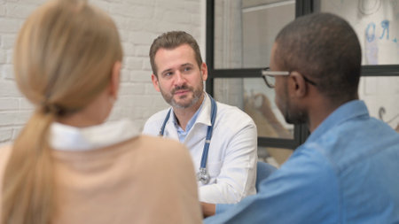 Close up of Male Doctor Talking with Coupleの写真素材