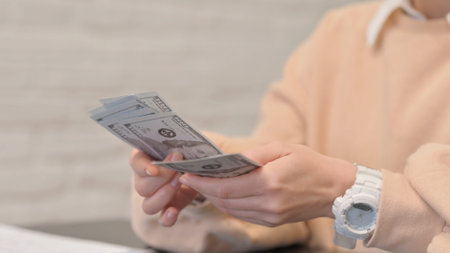 Close up of Female Hands Counting Moneyの写真素材