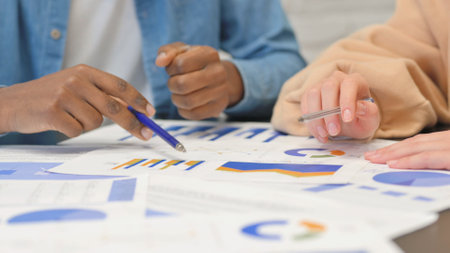 Close up of Mixed Race People Working on Documents