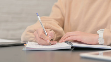 Close up of Female Hand Writing on Paperの写真素材