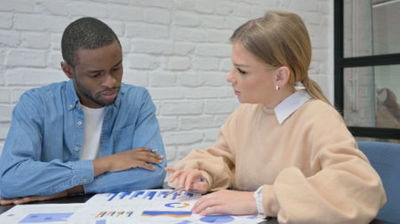 Young People Discussing Business Report, Mixed Raceの写真素材
