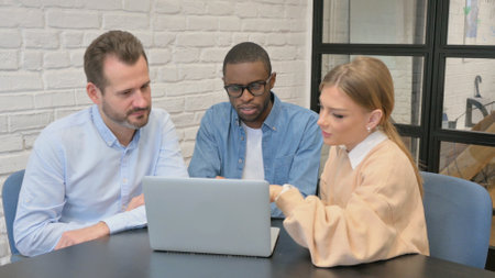 Multi Ethnic People Working on Laptop in Officeの写真素材