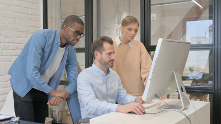 Multi Ethnic Young People Working on Computerの写真素材