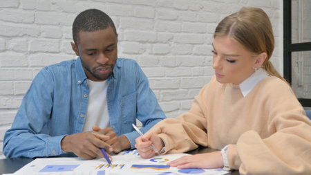 Young People Doing Paperwork in Officeの写真素材