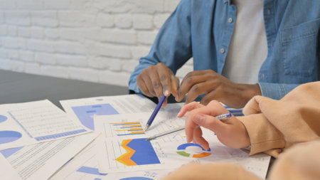 Hands of Multi Ethnic Teammates Doing Paperwork, Close up
