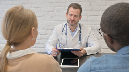 Doctor Talking with Mixed Race Coupleの写真素材