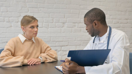 Doctor Discussing Medical Report with Patientの写真素材