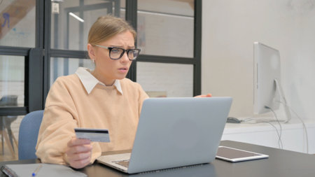 Female Worker Upset with Online Shopping Failure on Laptopの写真素材