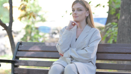 Serious Young Businesswoman Sitting on Benchの写真素材
