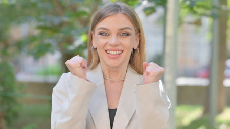 Outdoor Portrait of Businesswoman Celebrating Successの写真素材
