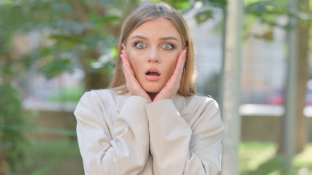 Shocked Businesswoman Wondering in Awe Outdoorの写真素材