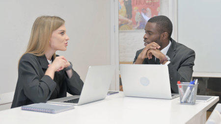 Business People Discussing Project while Sitting in Officeの写真素材