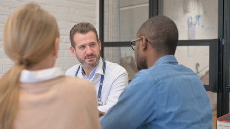 Close up of Interracial Couple Discussing Health Issues with Doctorの写真素材