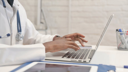 Close up of African Doctor Hands Typing on Laptopの写真素材