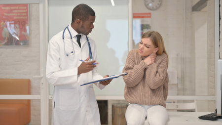 Woman with Neck Pain Consulting an African Orthopedic Doctorの写真素材