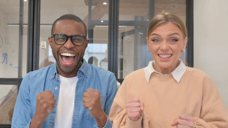 Group of happy business people celebrating success at office. Cheerful business people celebrating success at workplace. Success and teamwork conceptの写真素材