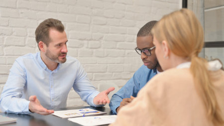 Entrepreneur in Discussion with Mixed Race Teammatesの写真素材